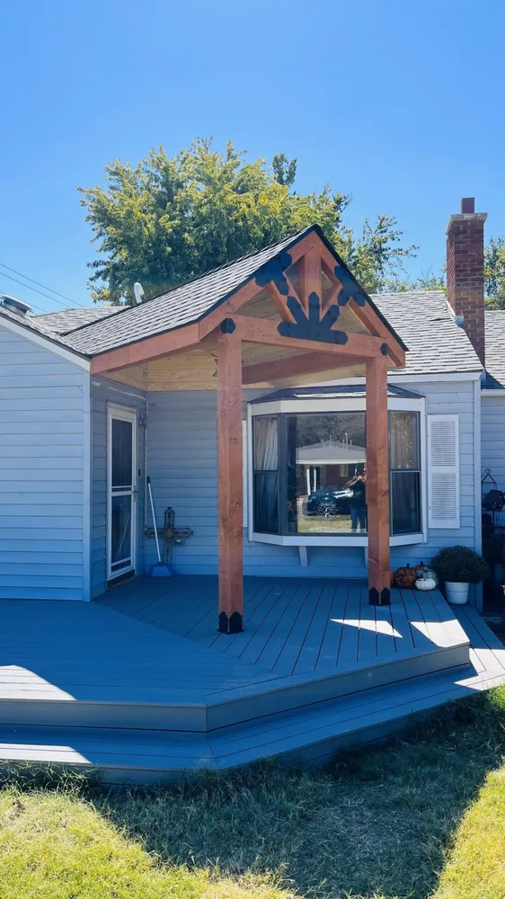 Covered porch addition with cedar posts, elk gable accent and grey deck boards