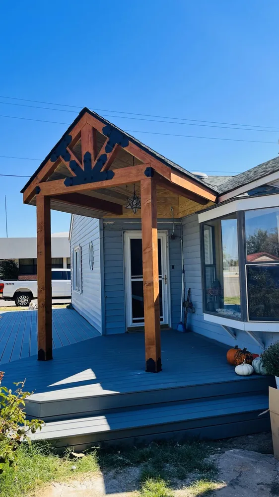 New covered front porch with a cedar gable and a decorative elk cut-out