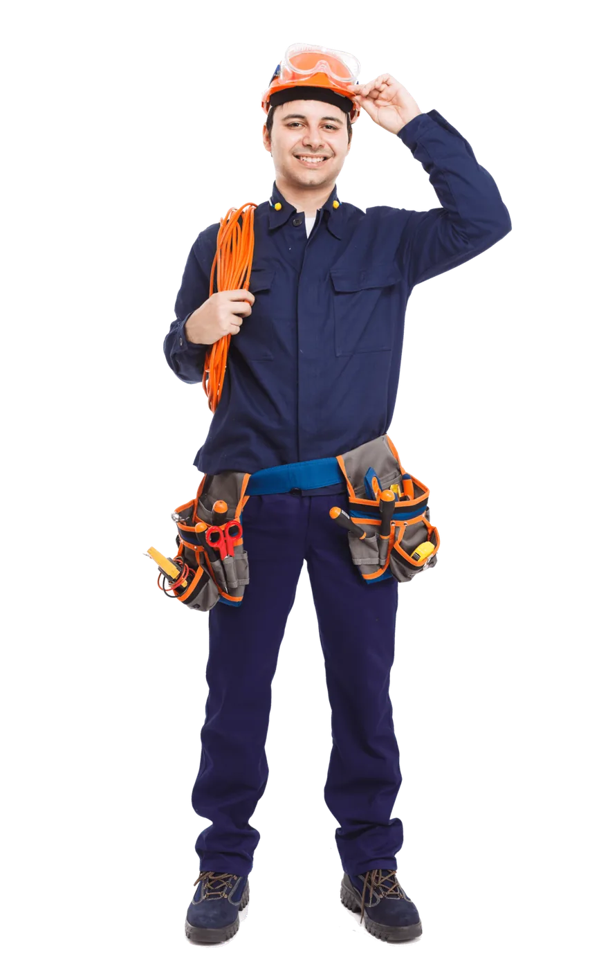 Electrician in navy coveralls and a hard hat wearing a tool belt and carrying a coil of orange cable